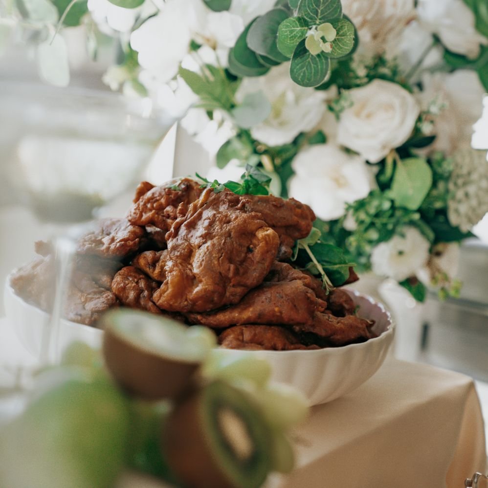 Food displayed with green and white flowers